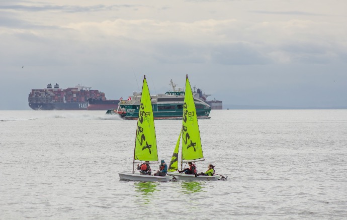 a group of people on small boats in the water